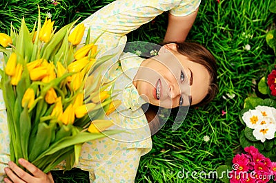cute girl with flowers on green grass Stock Photo