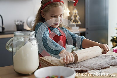 Girl focus on rolling gingerbread dough Stock Photo