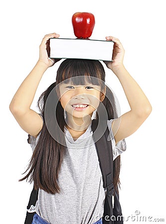 Cute girl holding book and apple on the head Stock Photo