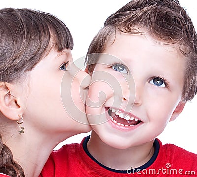 Cute girl kissing a blue eyed boy Stock Photo