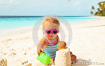 Cute girl little play with sand on beach Stock Photo