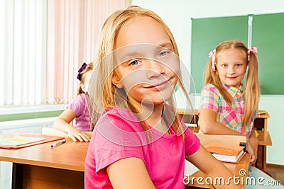 Cute girl looking sitting in classroom Stock Photo