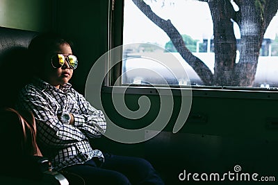Cute girl looking through window. She travels on a train. Stock Photo