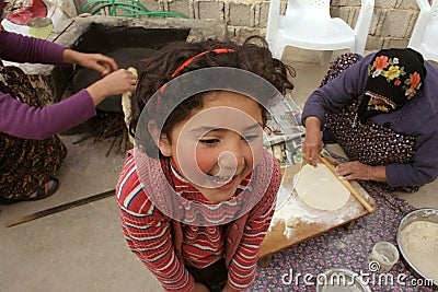 Cute girl loughing while waiting for pastry Stock Photo