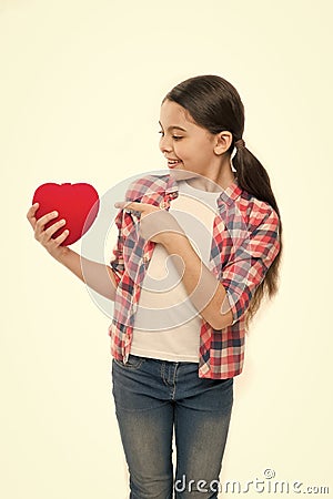 Cute girl in love. Little girl pointing finger at red heart. Little child expressing love on valentines day. Having Stock Photo