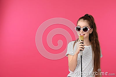 Cute girl with microphone on color background Stock Photo