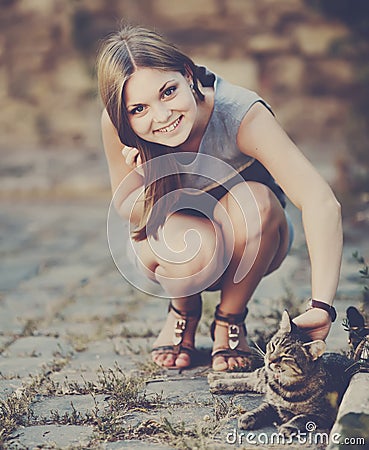 Cute girl playing with cat Stock Photo