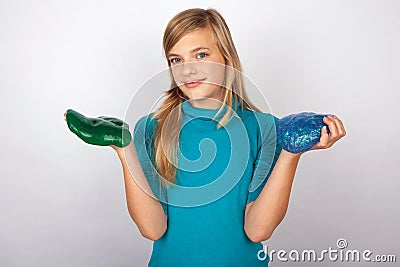 Cute girl showing a green and a blue slime Stock Photo