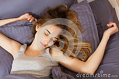 Cute girl sleeping in bed after hard week at home Stock Photo