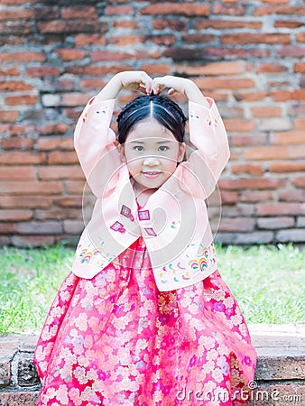 Cute girl wearing Korea costumes show love symbol hand. Stock Photo