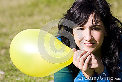 Cute girl with yellow colored balloon Stock Photo