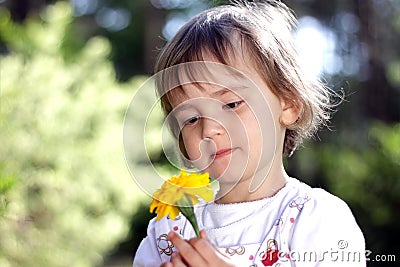 Cute girl with yellow flower Stock Photo