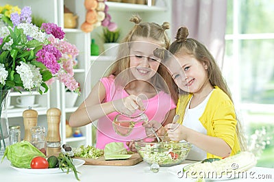 Cute girls preparing delicious fresh salad Stock Photo