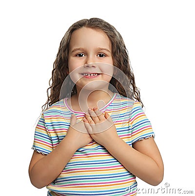 Cute grateful little girl with hands on chest, white Stock Photo