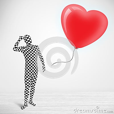 Cute guy in morpsuit body suit looking at a balloon shaped heart Stock Photo