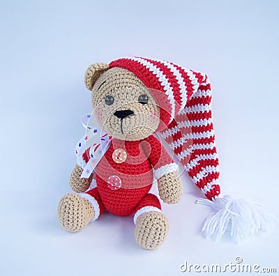 Cute handmade crochet bear doll on white background with shadow reflection. Stock Photo