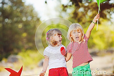 Cute happy children playing in spring filed Stock Photo