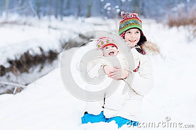 Cute happy laughing brother and baby sister in snow Stock Photo