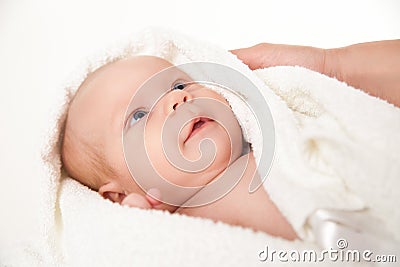 Cute happy little baby hidden in white towels Stock Photo