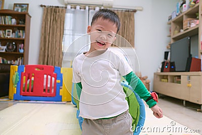 Cute happy smiling Asian little boy playing and having fun inside toy tunnel tube indoor at home Stock Photo