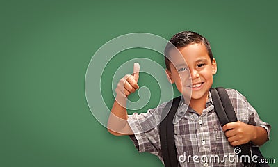 Cute Hispanic Boy In Front of Blank Chalk Board Stock Photo