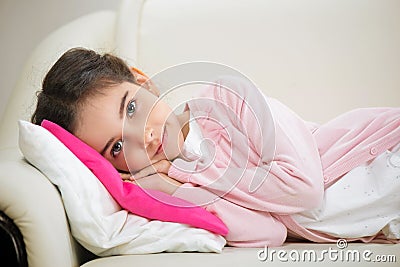 Cute hispanic girl lying in bed Stock Photo