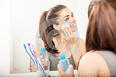 Cute Hispanic woman removing her makeup Stock Photo