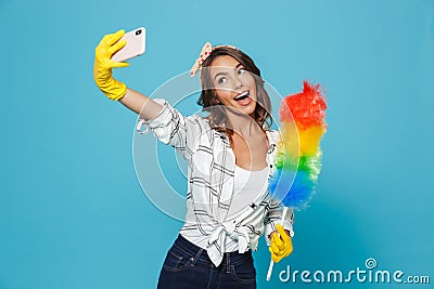 Cute housewife 20s in yellow rubber gloves for hands protection Stock Photo