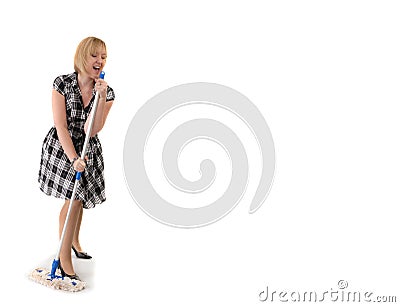 Cute housewife sings to broom handle Stock Photo