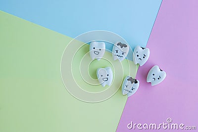 Icons of healthy and decayed teeth on pastel background for kid education Stock Photo