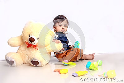 Cute Indian baby child playing with toy Stock Photo