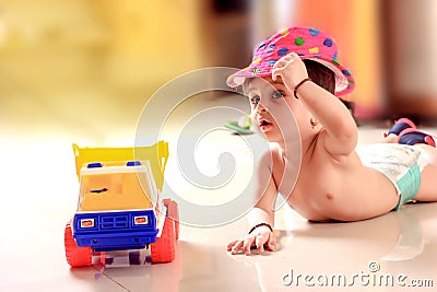 Cute Indian baby child playing with toy Stock Photo