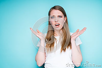 A cute indignant girl with blond hair makes a helpless gesture of not knowing Stock Photo