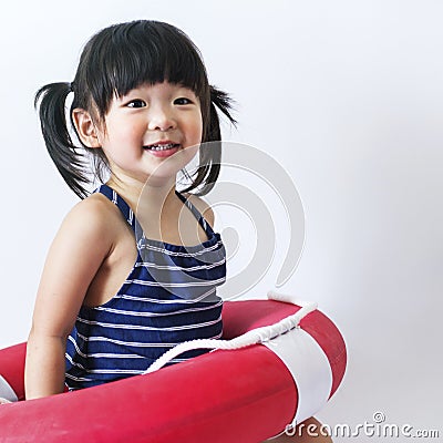 Cute and innocent asian kid with life ring on white backgroun Stock Photo