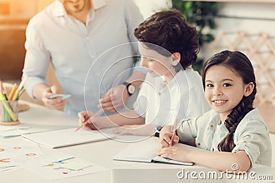 Cute intelligent girl doing her hometask Stock Photo