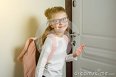 Cute junior schoolgirl with blond hair going to school, standing Stock Photo