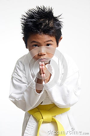 Cute Karate kid bowing Stock Photo