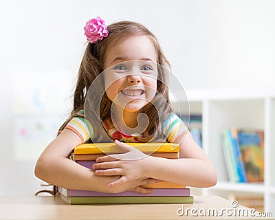 Cute kid girl preschooler with books Stock Photo
