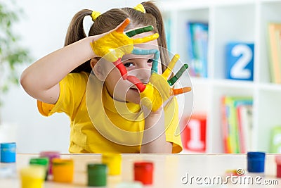 Cute kid have fun painting her hands Stock Photo