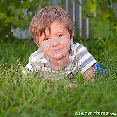 Cute kid having outside activities. Child on the grass. Stock Photo