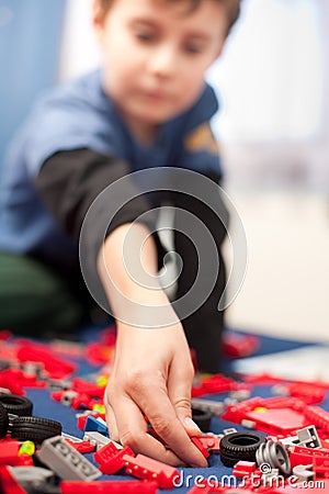 Cute kid playing with plastic blocks Stock Photo