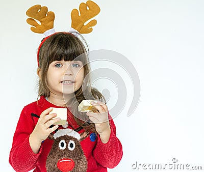 Cute kid wears in Christmas clothes and opening gift box. Christmas gifts and Christmas presents concept Stock Photo