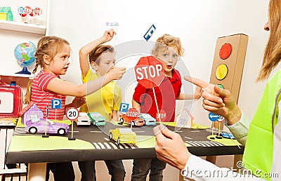 Cute kids having fun teaching traffic signs Stock Photo