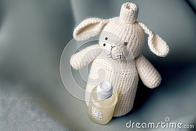 cute kids knitted toys little white bunny with baby nipple Stock Photo
