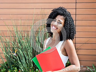 Cute latin female student woman with curly black hair Stock Photo