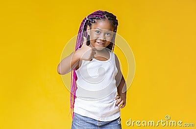 Cute little afro girl showing thumb up, recommending something Stock Photo
