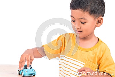 Cute little asian boy child kid preschooler playing toy car Stock Photo