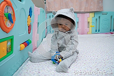 Cute little asin baby boy sitting and play toy in room Stock Photo