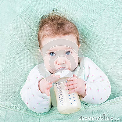 Cute little baby drinking milk formula out of bottle Stock Photo