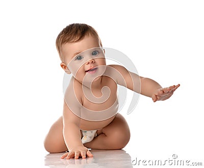 Cute little baby girl infant in diaper try to creep on floor smiling and looking aside isolated on white background Stock Photo